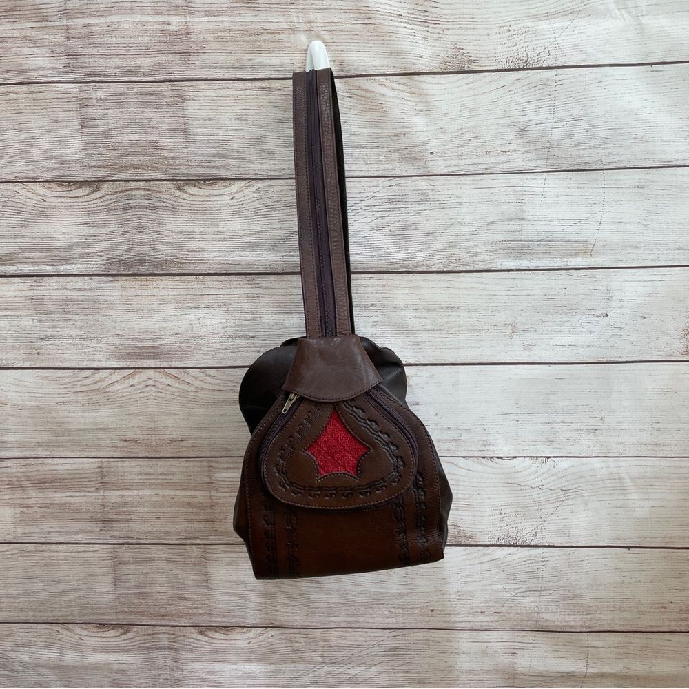 VINTAGE TOOLED LEATHER BACKPACK/SLING BAG IN BROWN